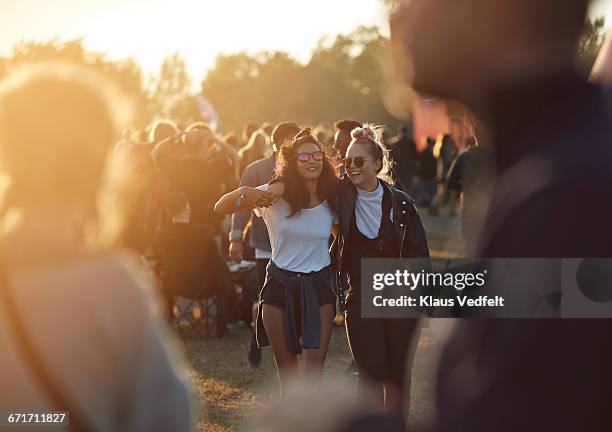 friends laughing together at big festival - festival stockfoto's en -beelden