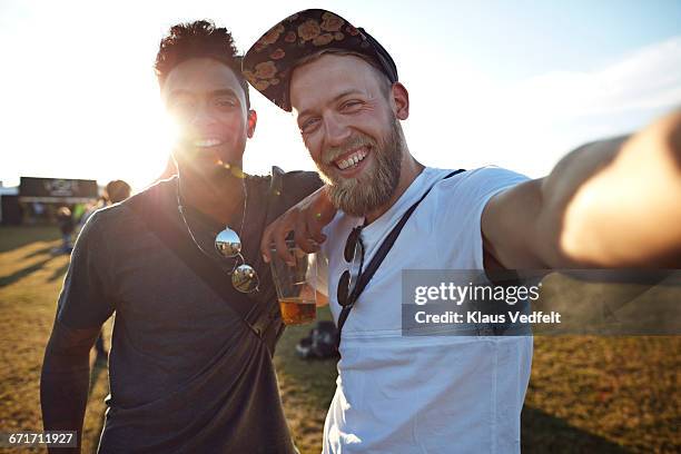 friends making selfie at big festival concert - gegenlicht stock-fotos und bilder