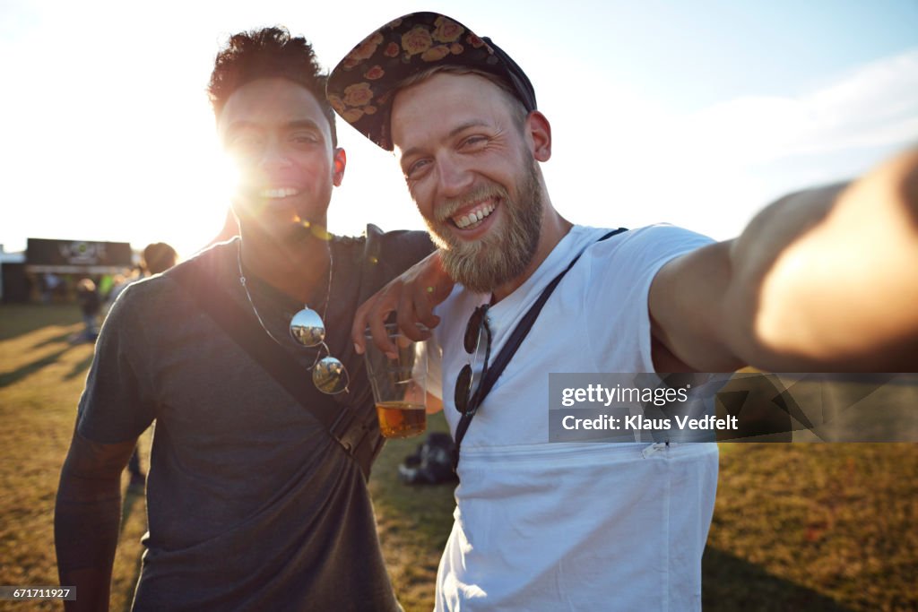 Friends making selfie at big festival concert