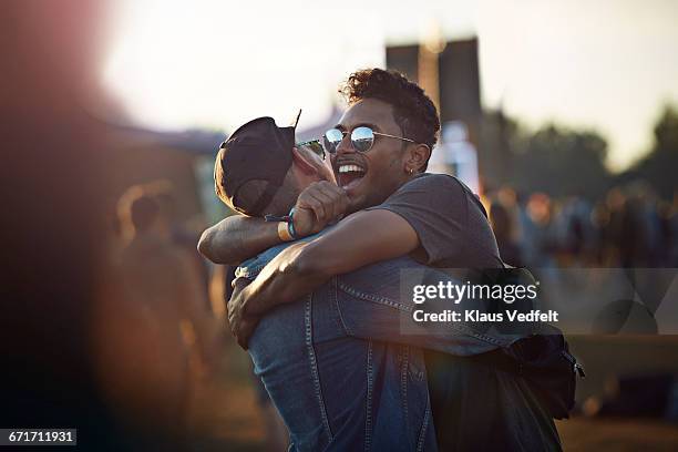 friends hugging & laughing at big festival - blue sunglasses stock pictures, royalty-free photos & images