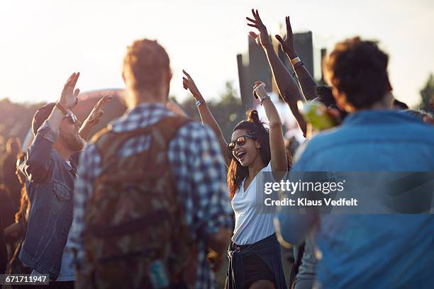 friends dancing together at festival concert - concert crowd stock pictures, royalty-free photos & images