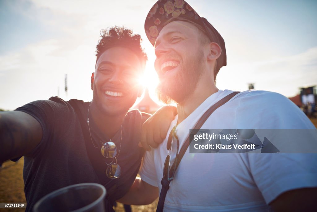 Friends making selfie at big festival concert