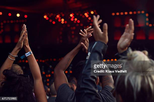 close-up of hands clapping at concert - concert foto e immagini stock