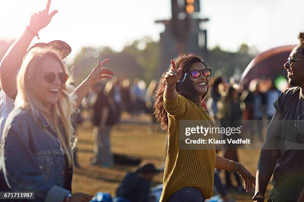 friends laughing at big festival concert - music festival day 4 stockfoto's en -beelden