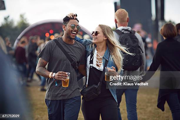 couple laughing together at concert - beer drinking stock pictures, royalty-free photos & images