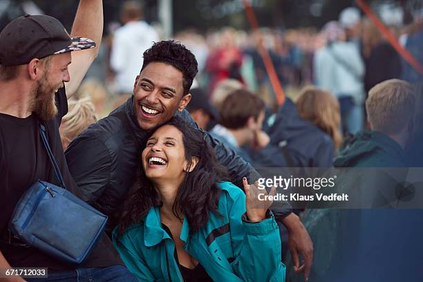 friends laughing together at outside concert - hangout festival day 3 stockfoto's en -beelden