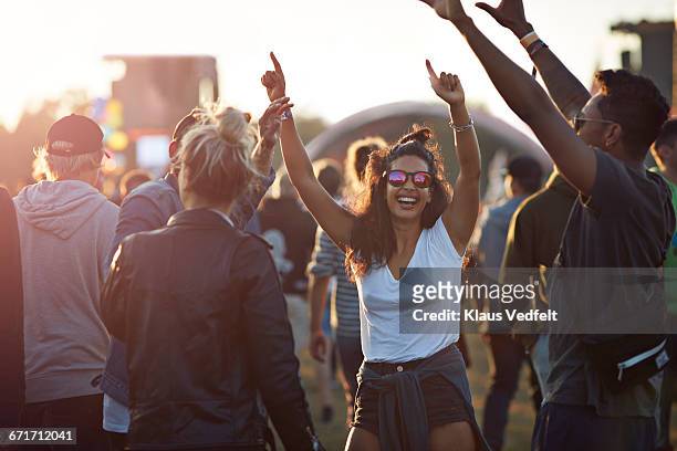 friends with arms in the air at festival concert - music festival stock pictures, royalty-free photos & images