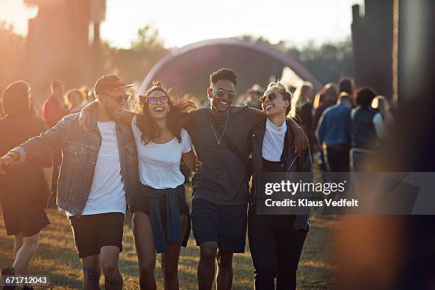 friends laughing together at big festival - konzert stock-fotos und bilder