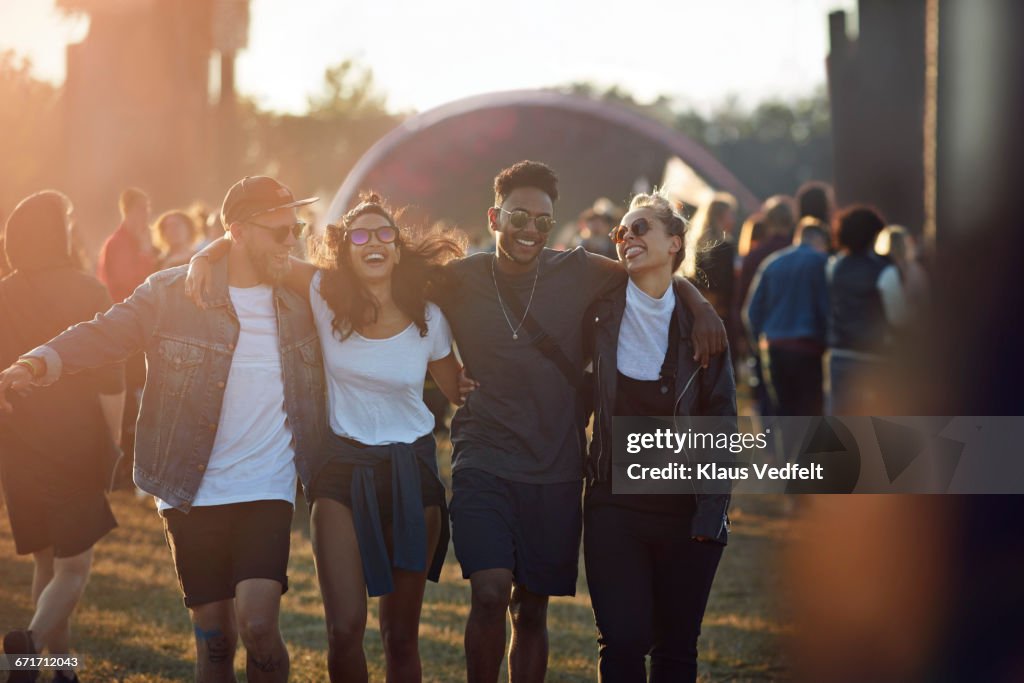 Friends laughing together at big festival