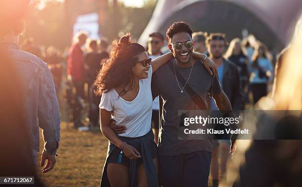 couple laughing together at big festival - concert foto e immagini stock