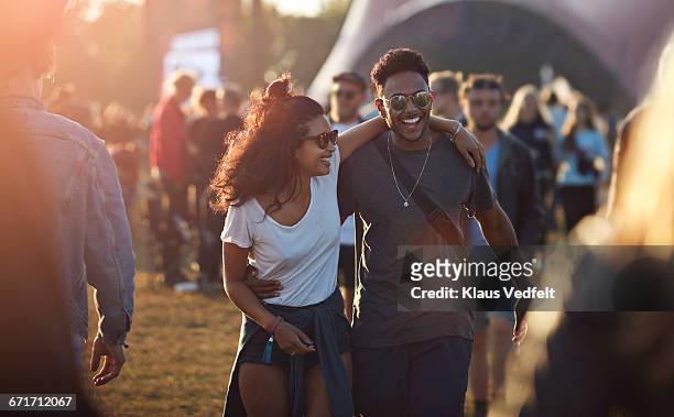 couple laughing together at big festival - music festival stock pictures, royalty-free photos & images