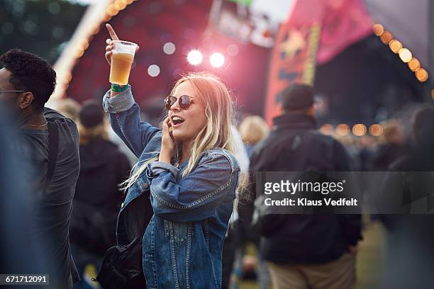 woman cheering with beer at concert - music festival stock pictures, royalty-free photos & images