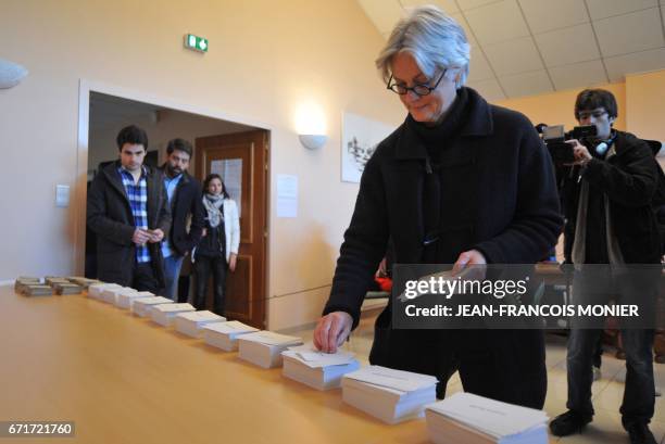 Penelope Fillon, the wife of French presidential election candidate for the right-wing Les Republicains party picks up ballots next to her sons...