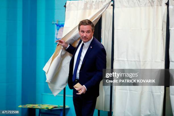 French presidential election candidate for the right-wing Debout la France party Nicolas Dupont-Aignan walks out a polling booth after casting his...