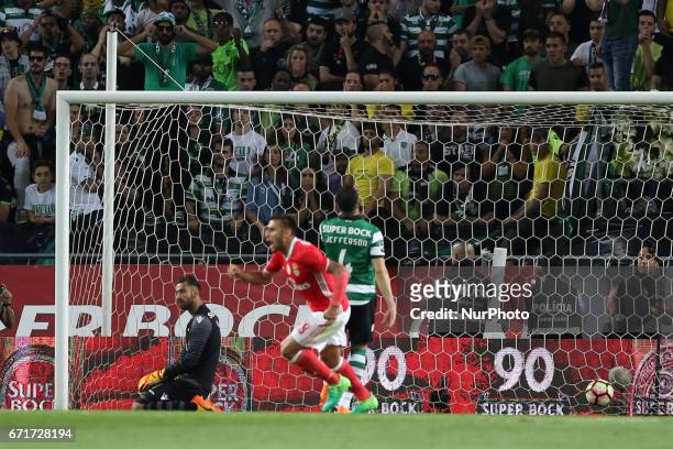 Benfica's Swedish defender Victor Lindelof beats Sporting's Portuguese goalkeeper Rui Patricio during the Portuguese League football match Sporting...