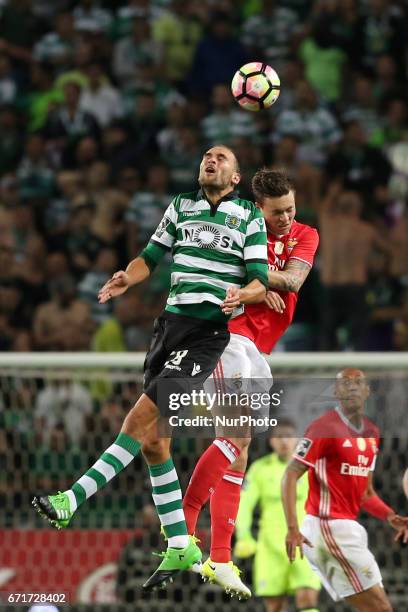 Sporting's Dutch forward Bas Dost heads the ball with Benfica's Swedish defender Victor Lindelof during the Portuguese League football match Sporting...