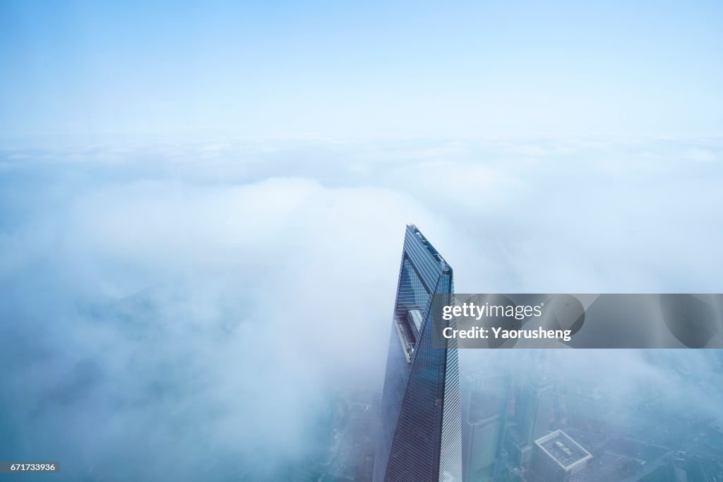 Shanghai World Finance center building in the fog,this building ,along with Jinmal building and Oriental Pear Tower are landmark of Shanghai city,located at Pudong area