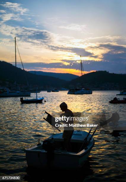 General view of a local man fishing at sunset on August 31, 2016 in Vis, Croatia.