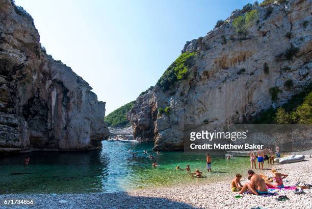 General view of tourists swimming and sunbathing on Stiniva beach on September 2, 2016 in Vis, Croatia.