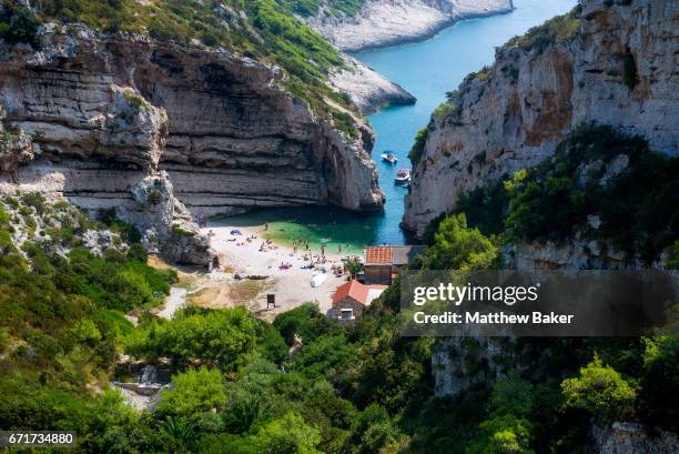 General view of tourists swimming and sunbathing on Stiniva beach on September 2, 2016 in Vis, Croatia.