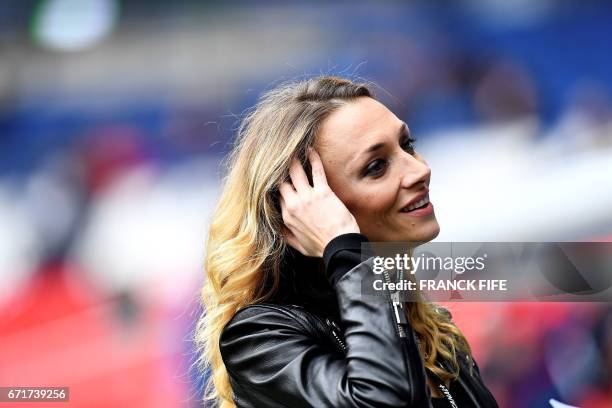 French TV host Laurie Delhos­tal reacts before the French L1 football match between Paris Saint-Germain and Montpellier at the Parc des Princes...