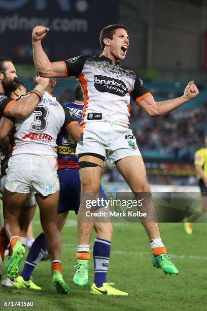 Mitch Moses of the Tigers celebrates victory with his team during the round eight NRL match between the Wests Tigers and the Canterbury Bulldogs at...