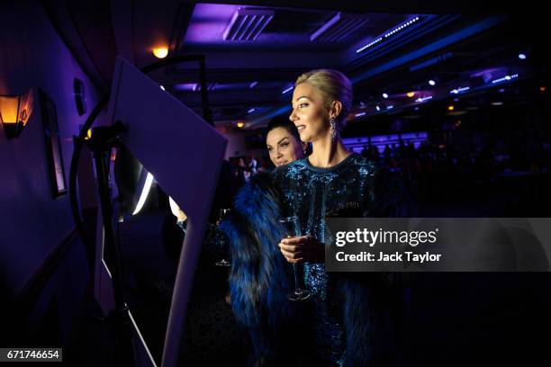 Guests take a photograph of themselves using a tablet at the grand final of Miss USSR UK at the Troxy on April 22, 2017 in London, England. The...