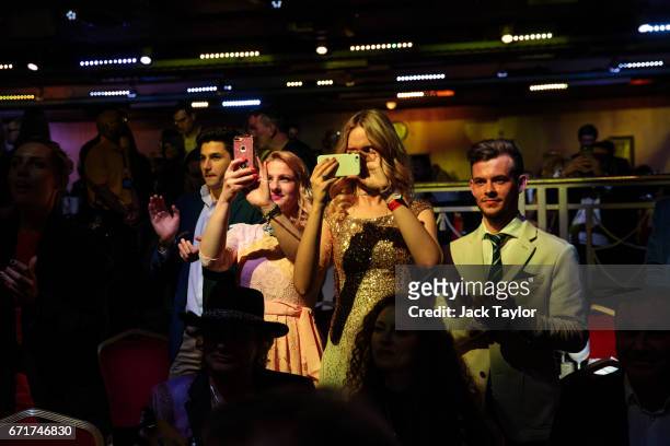 Members of the audience look on and take pictures during the grand final of Miss USSR UK at the Troxy on April 22, 2017 in London, England. The...