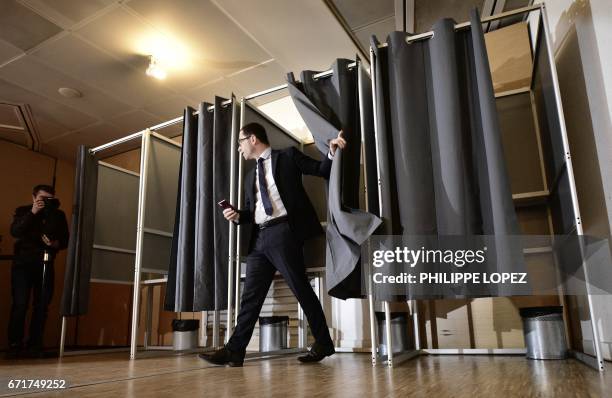 French presidential election candidate for the left-wing French Socialist party Benoit Hamon leaves a polling booth as he votes at a polling station...