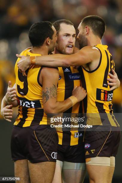 Jarryd Roughead of the Hawks celebrates a goal with Shaun Burgoyne of the Hawks and Jack Gunston of the Hawks during the round five AFL match between...
