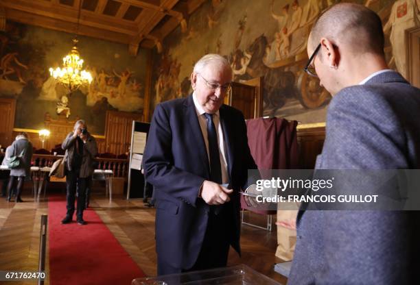 French presidential election candidate for the Solidarite et Progres party Jacques Cheminade prepares to cast his vote at a polling station in Paris,...