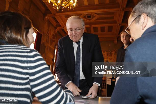 French presidential election candidate for the Solidarite et Progres party Jacques Cheminade prepares to vote at a polling station in Paris, on April...