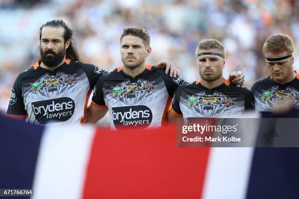 Aaron Woods, Chris Lawrence, Matt Mcllwrick and Joel Edwards of the Tigers watches on during the ANZAC ceremony before the round eight NRL match...