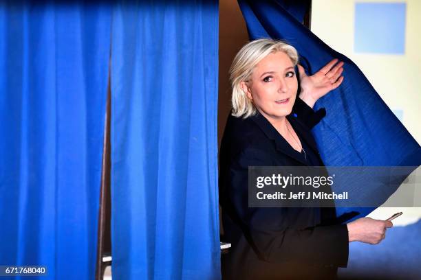 National Front Leader Marine Le Pen, casts her vote for the French elections in a polling station on April 23, 2017 in Henin Beaumont, France. French...