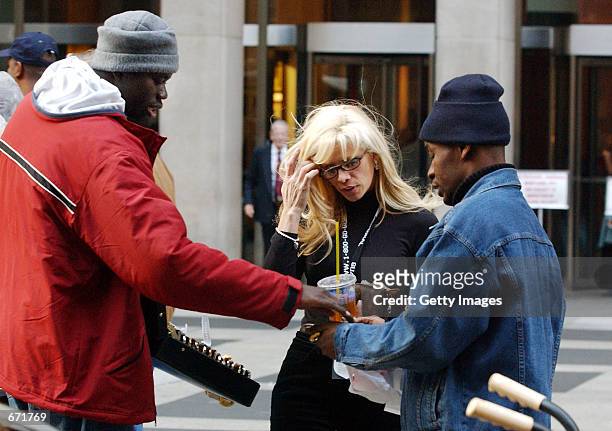 Victoria Gotti, daughter of imprisoned mob boss John Gotti, shops for a watch from street vendors November 16, 2001 on Sixth Avenue in New York City.