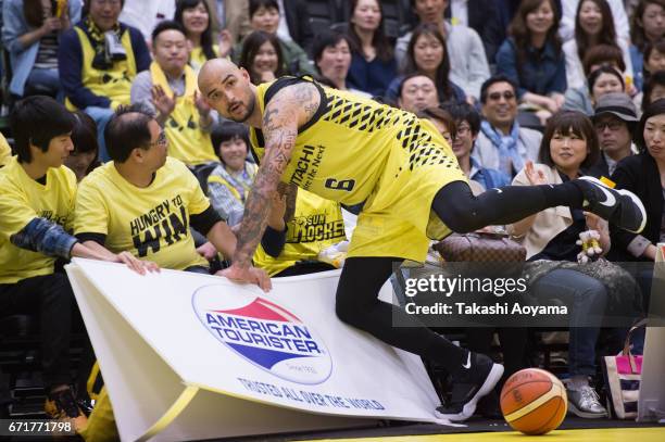 Robert Sacre of the SunRockers dives into the audience chaseing a loose ball during the B. League match between Hitachi SunRockers Tokyo-Shibuya and...