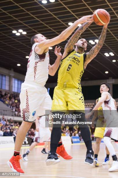 Robert Sacre of the SunRockers contests a rebound with Nick Fazekas of the Kawasaki Brave Thunders during the B. League match between Hitachi...