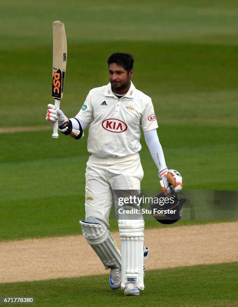 Surrey batsman Kumar Sangakkara raises his bat after reaching his century on day three of the Specsavers County Championship: Division One between...