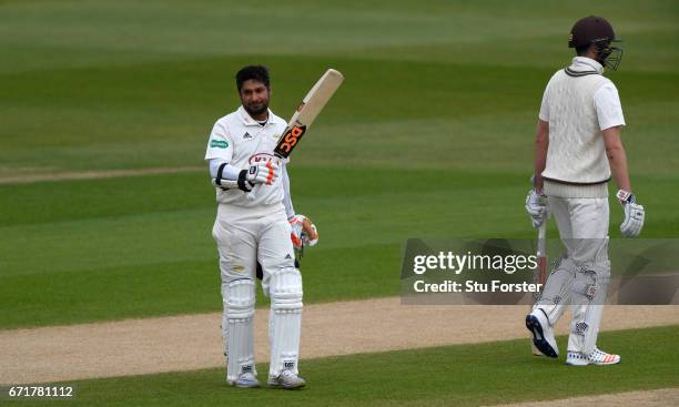 Surrey batsman Kumar Sangakkara raises his bat after reaching his century on day three of the Specsavers County Championship: Division One between...