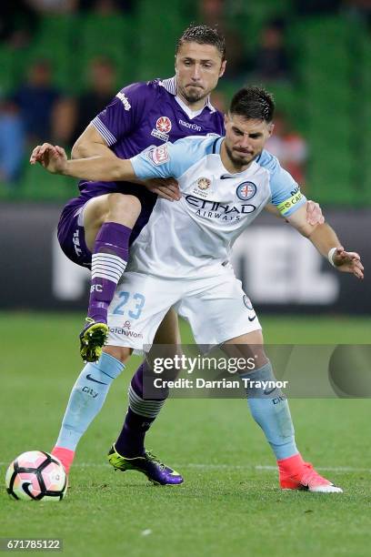 Dino Djulbic of Perth Glory defends against Bruno Fornaroli of Melbourne City during the A-League Elimination Final match between Melbourne City FC...