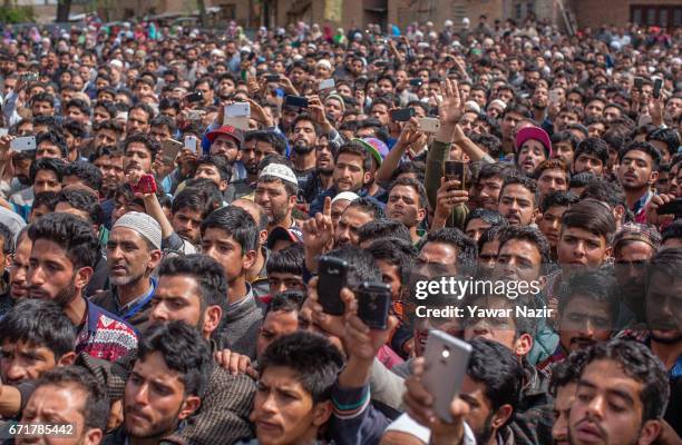 Kashmiri Muslims gather to attend the funeral procession of Younis Maqbool Ganie, a pro Kashmir rebel killed in a gun battle with Indian government...