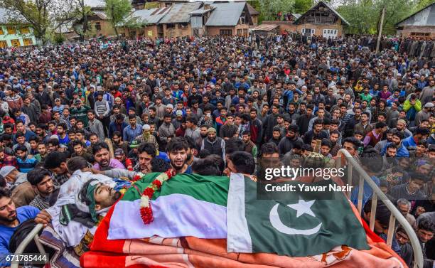 Kashmiri Muslims carry the body of Younis Maqbool Ganie, a pro Kashmir rebel killed in a gun battle with Indian government forces, during his funeral...