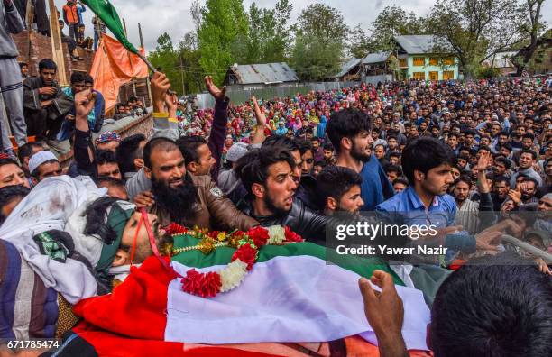 Kashmiri Muslims gather around the body of Younis Maqbool Ganie, a pro Kashmir rebel killed in a gun battle with Indian government forces, during his...