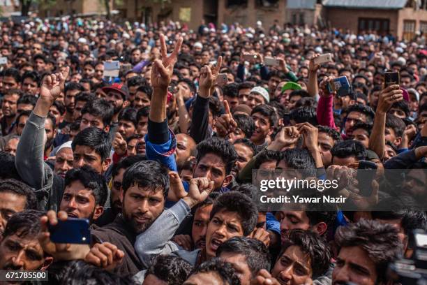 Kashmiri Muslims chant anti Indian and pro Kashmir freedom slogans as they attend the funeral procession of Younis Maqbool Ganie, a pro Kashmir rebel...