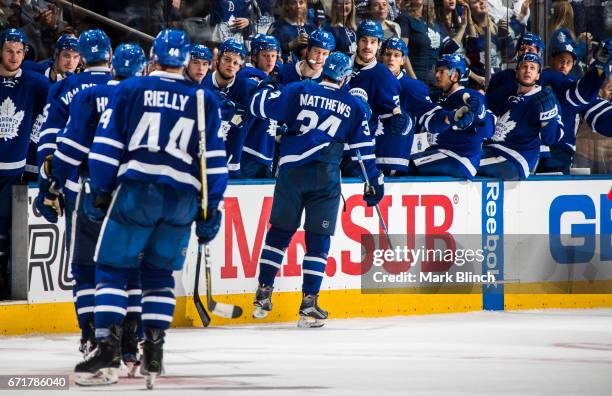 Auston Matthews of the Toronto Maple Leafs celebrates his goal with the bench against the Washington Capitals during the third period in Game Four of...