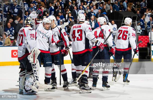 Nate Schmidt congratulates Braden Holtby of the Washington Capitals after they defeated the Toronto Maple Leafs during the third period in Game Four...