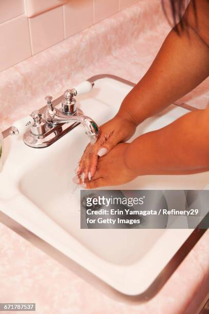 young woman washing hands - 67percentcollection bildbanksfoton och bilder