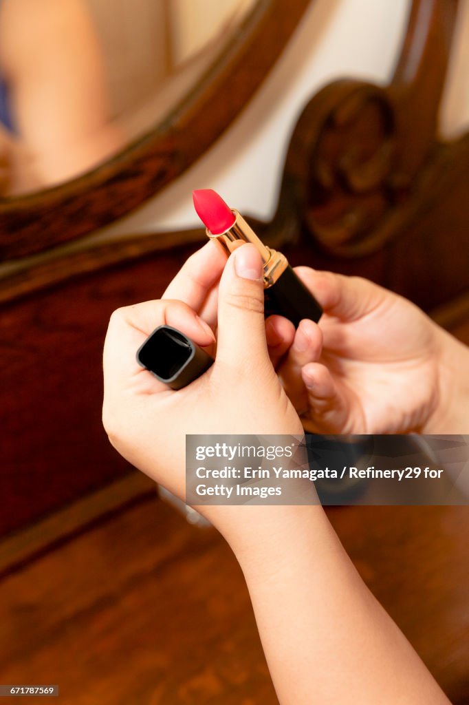 Young Woman Holding Lipstick