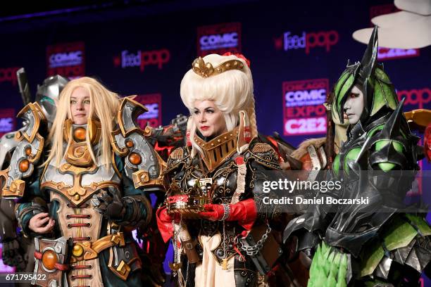 Cosplay contest winners dressed as a Blood Elf Priest from "World of Warcraft," a Ordo Hereticus Inquisitor from "Warhammer 40k" attend a Monster...
