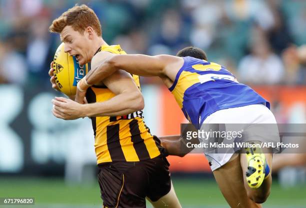 Tim O'Brien of the Hawks is tackled by Josh Hill of the Eagles during the 2017 AFL round 05 match between the Hawthorn Hawks and the West Coast...